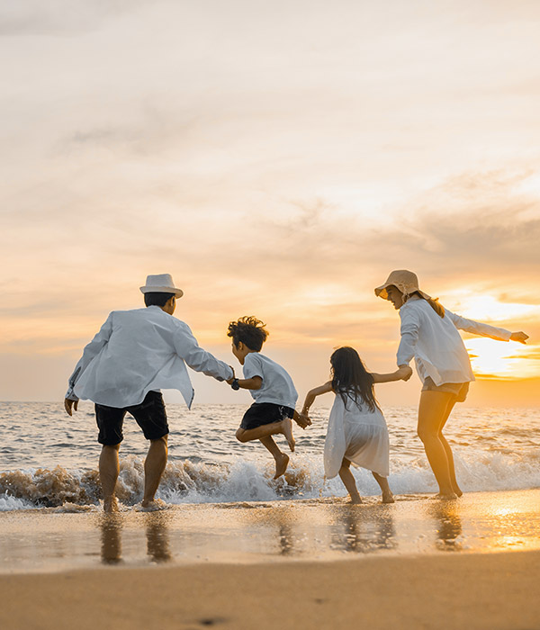Family on the beach at sunset end date